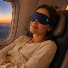 Woman relaxing on an airplane with Zunada heated silk eye mask
